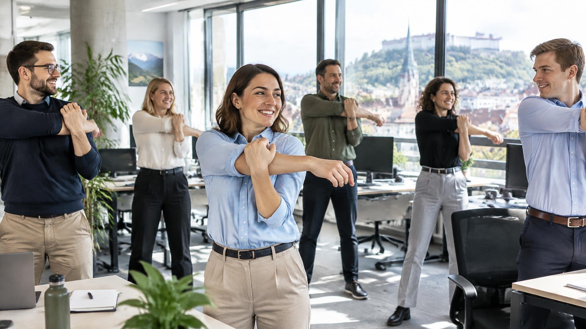 Group of office employees stretching together during a workplace wellness break